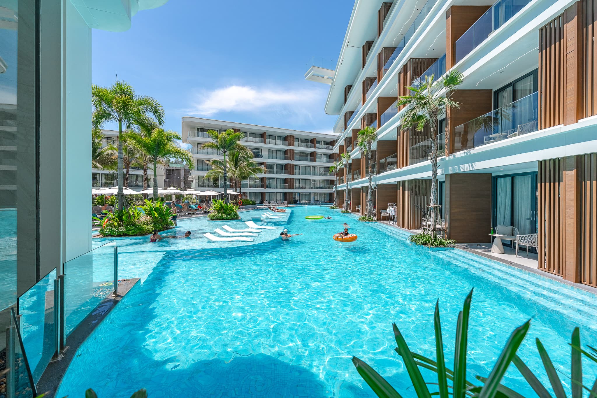 Lagoon pool running between the buildings of a Phuket condominium