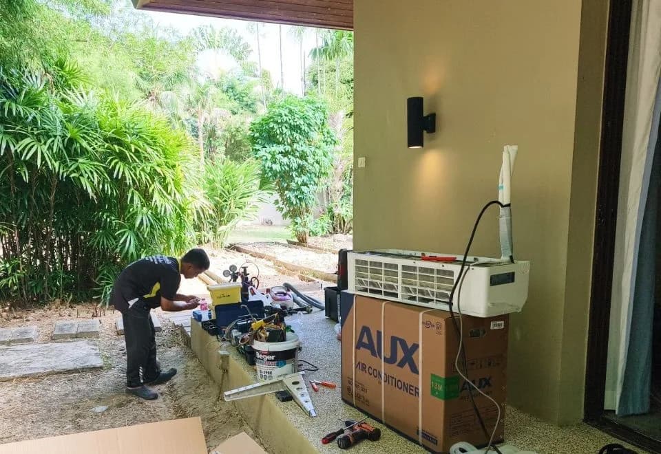 New air conditioning units and tools laid out before installation at a Phuket villa
