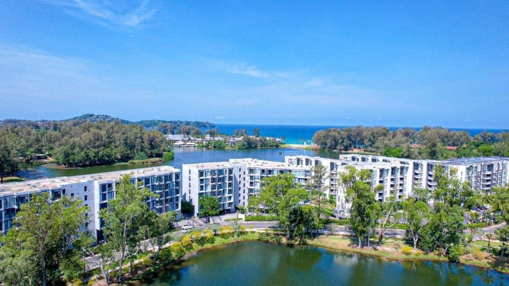 Aerial view of a modern condominium complex near a lagoon and the sea in Phuket, Thailand