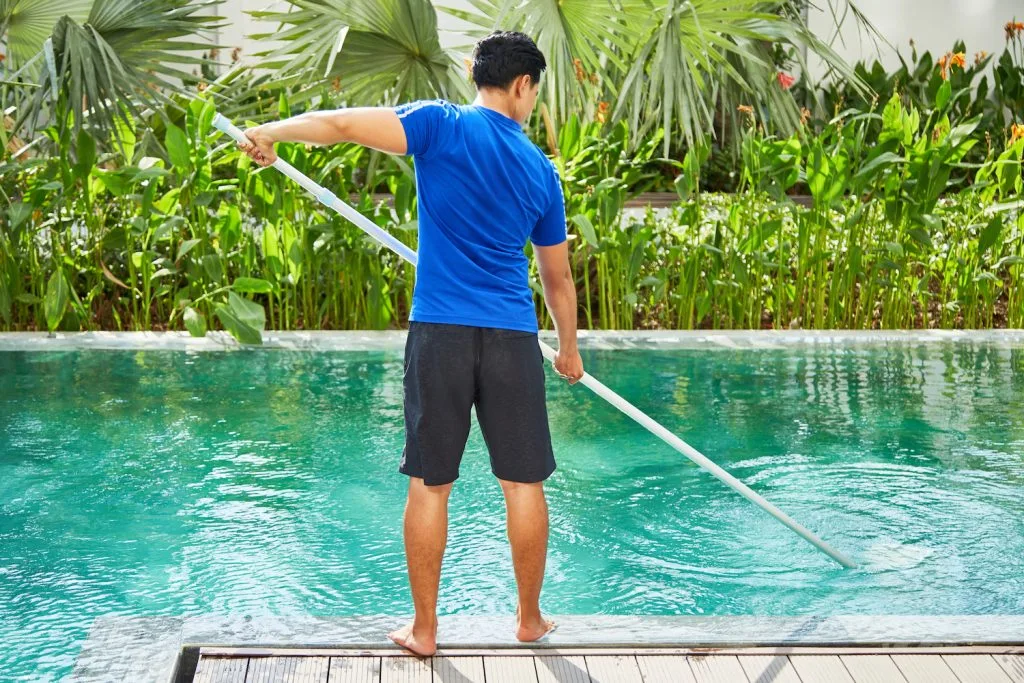 Professional pool cleaning service at a luxury villa in Phuket, ensuring crystal-clear water and top-tier property maintenance.